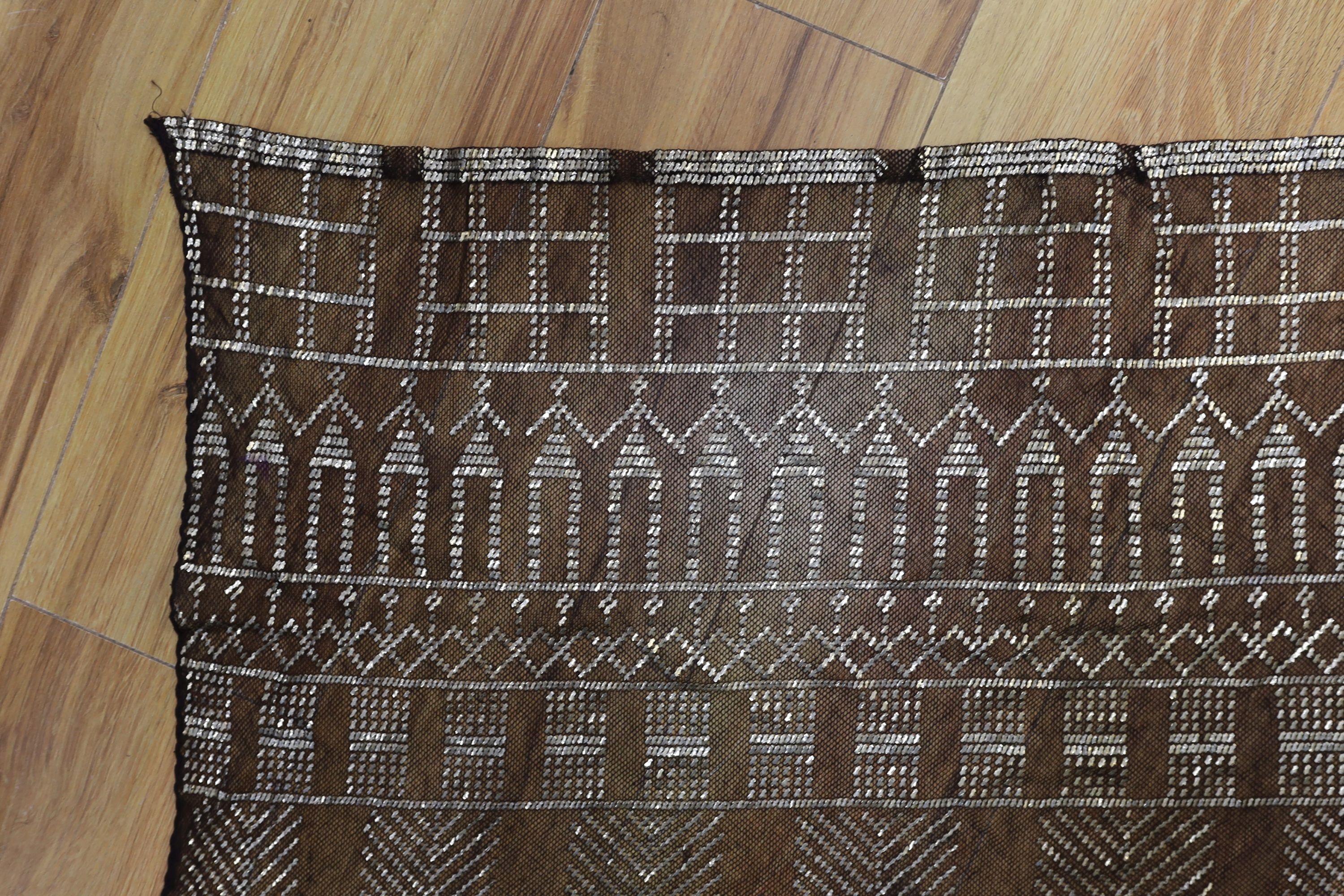 A dress made from a metal and black net Egyptian shawl; a similar shawl and a piece of shawl